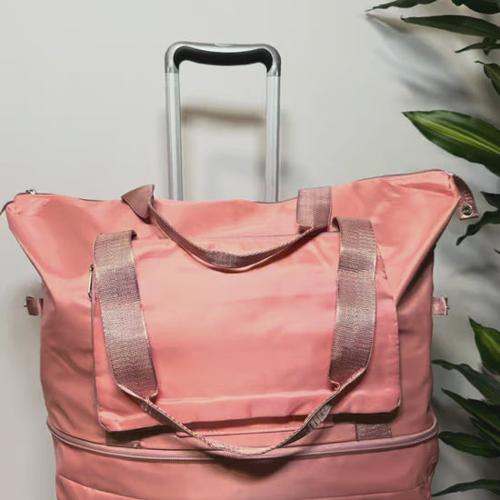 Video demostrativo bolso viaje rosa plegable con ruedas giratorias